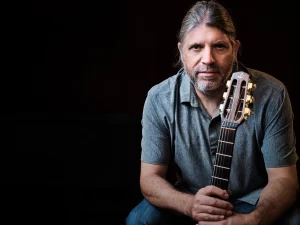 A snapshot of Stephane Wrembel holding a guitar